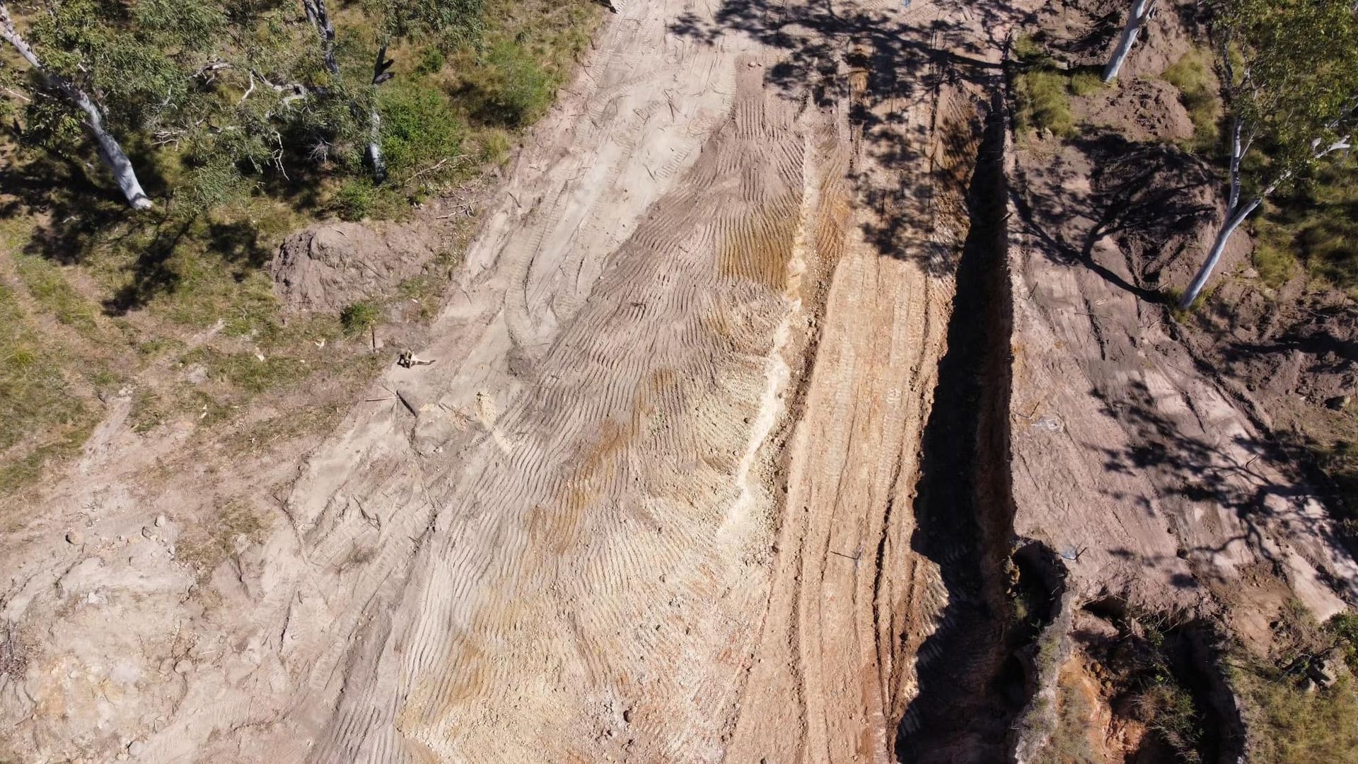 Aerial View of a Deep Ravine With Layered Earth Tones and Sparse Vegetation — Macca's Dynamic Earthworks in Tolga, QLD
