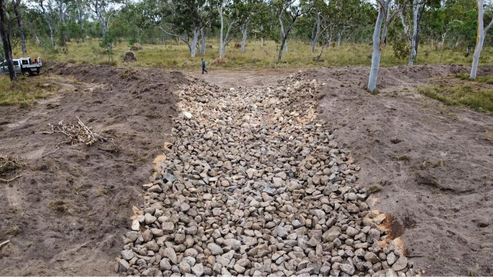River Flows Past Grassy Banks and Hills — Macca's Dynamic Earthworks in Tolga, QLD