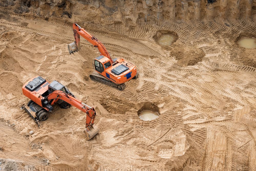 Two Orange Excavators Digging in Dirt — Macca's Dynamic Earthworks in Tolga, QLD