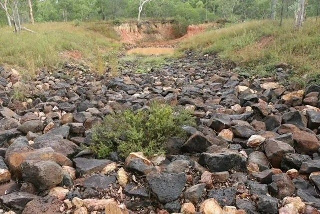 Rocky Creek Bed with Dry Rocks and Sparse Vegetation — Macca's Dynamic Earthworks in Tolga, QLD
