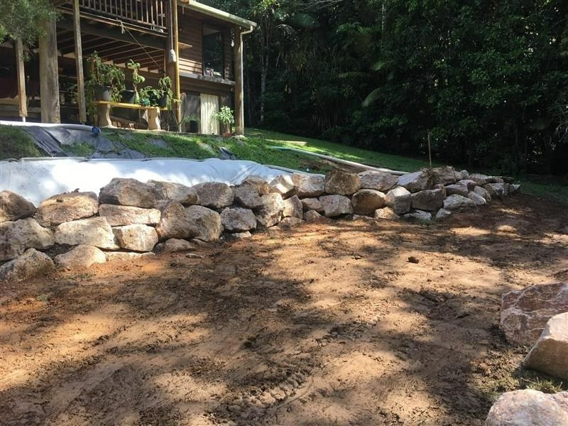 Stone Retaining Wall in Front of A House — Macca's Dynamic Earthworks in Tolga, QLD