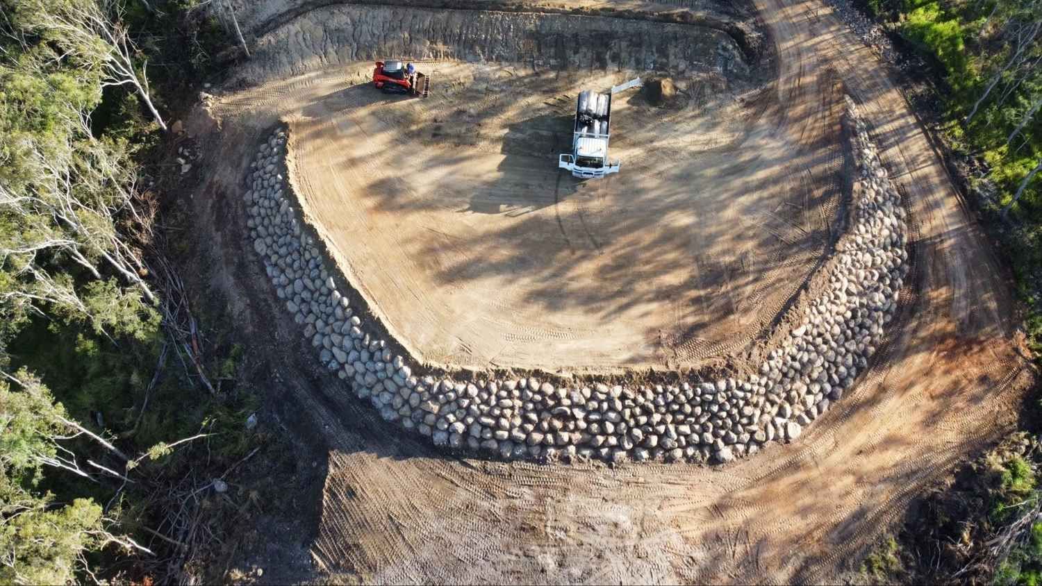 Aerial View of Earthworks with A Curved Rock Wall — Macca's Dynamic Earthworks in Tolga, QLD
