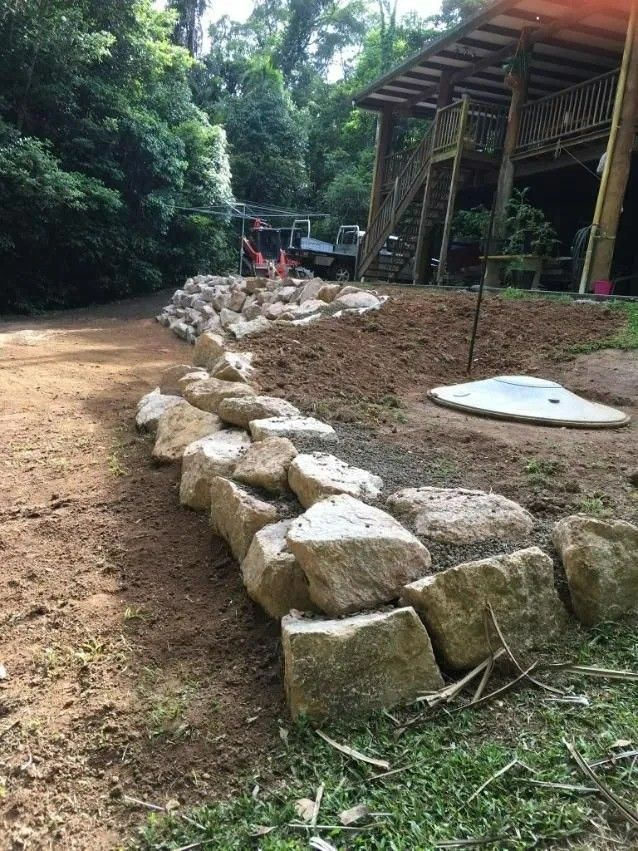 Stone Retaining Wall Under Construction — Macca's Dynamic Earthworks in Atherton, QLD