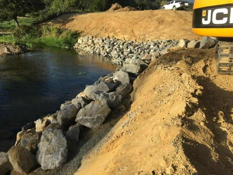 Rocks Lining the Water Edge — Macca's Dynamic Earthworks in Tablelands, QLD