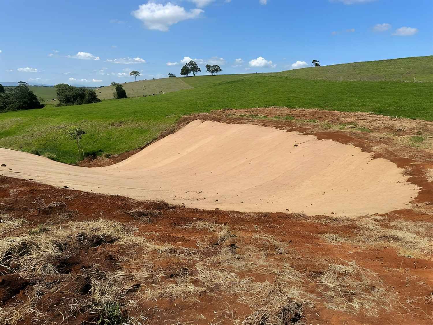 Brown Sand Pile on Dirt Road — Macca's Dynamic Earthworks in Tolga, QLD