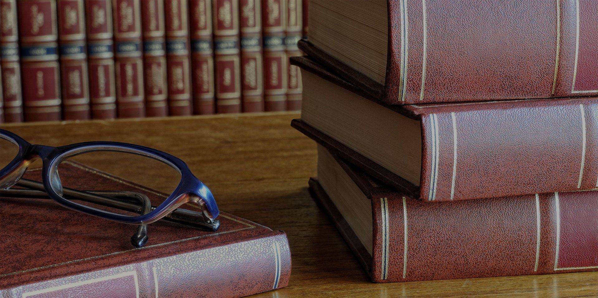 a pair of glasses sits on top of a stack of books