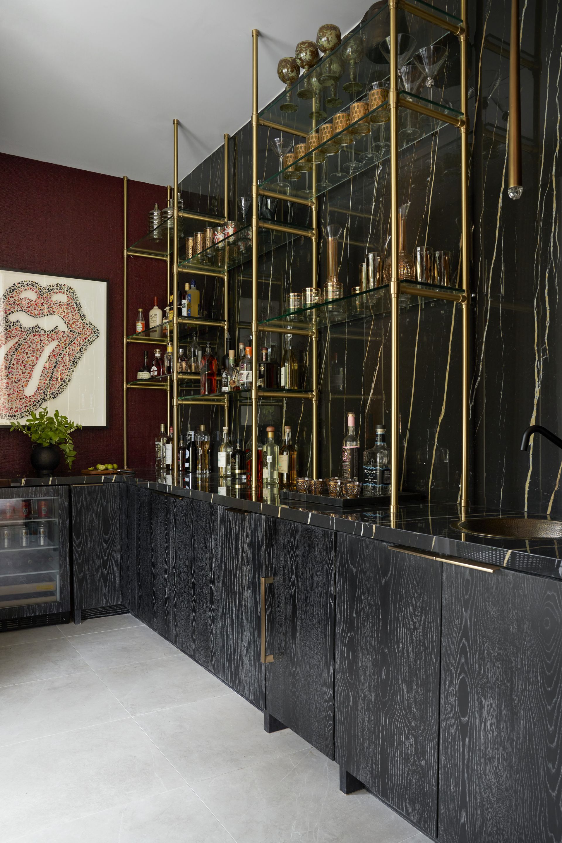 a kitchen with a rolling stones painting on the wall