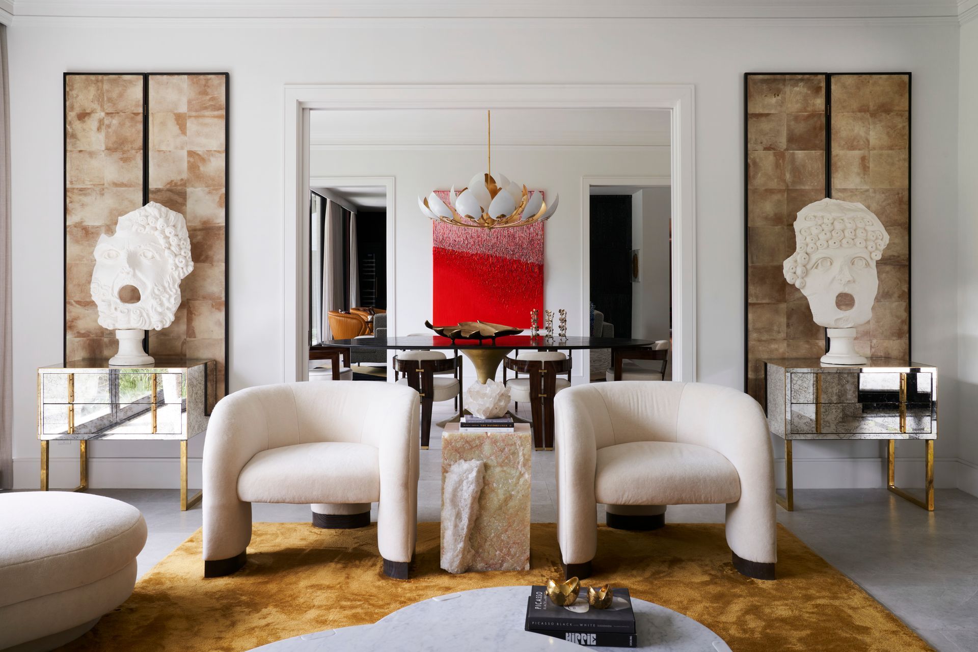 a living room with two white chairs and a coffee table .