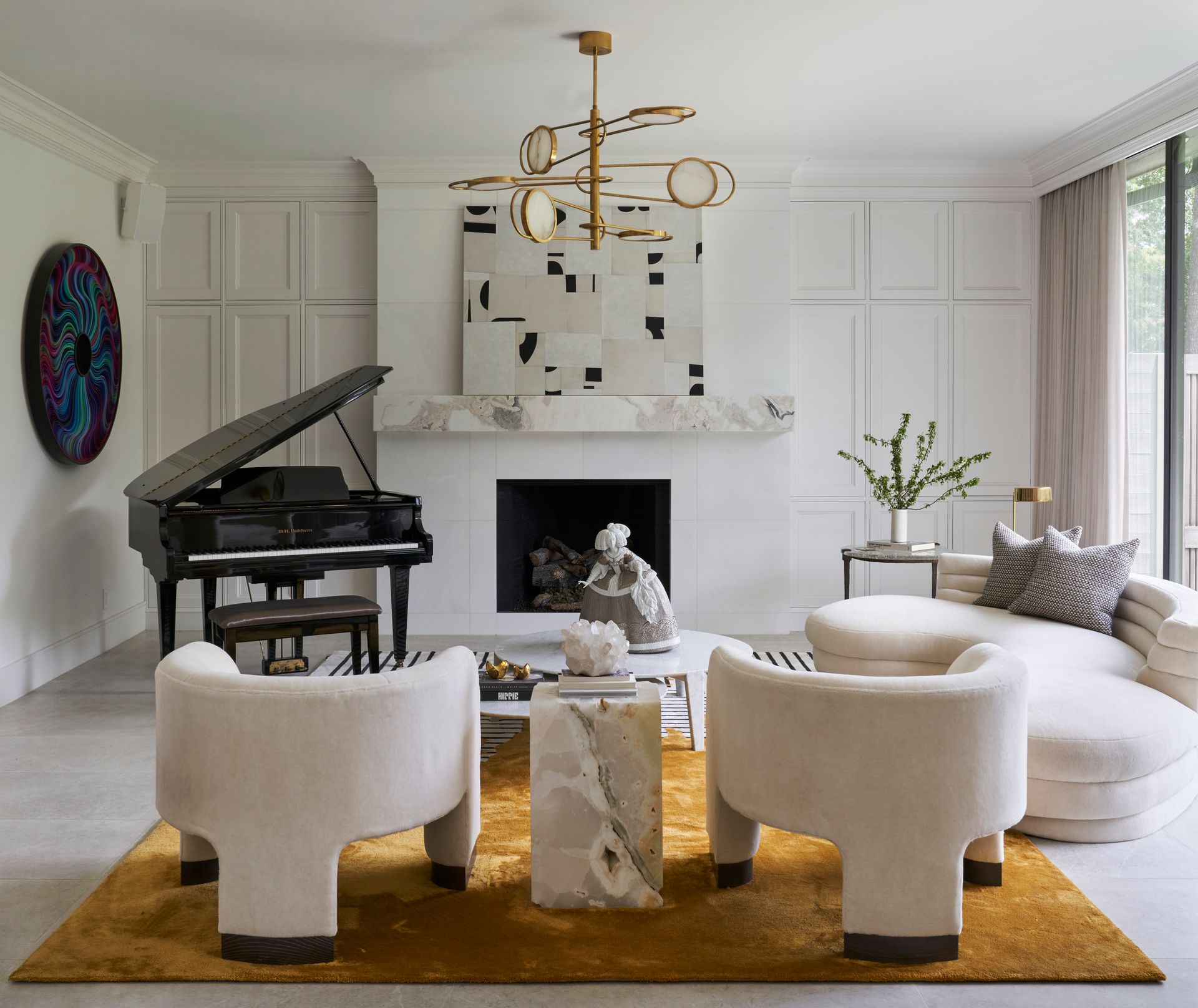 a living room with a piano , chairs , a couch and a fireplace .