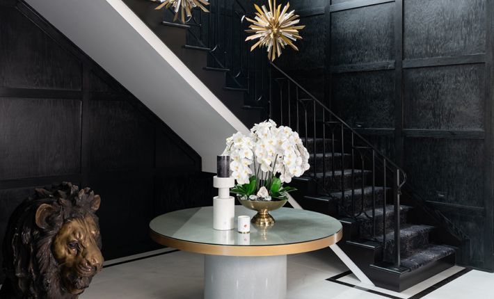 A living room with red walls and a purple couch