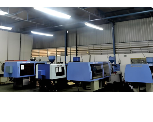 A row of plastic injection molding machines in a factory