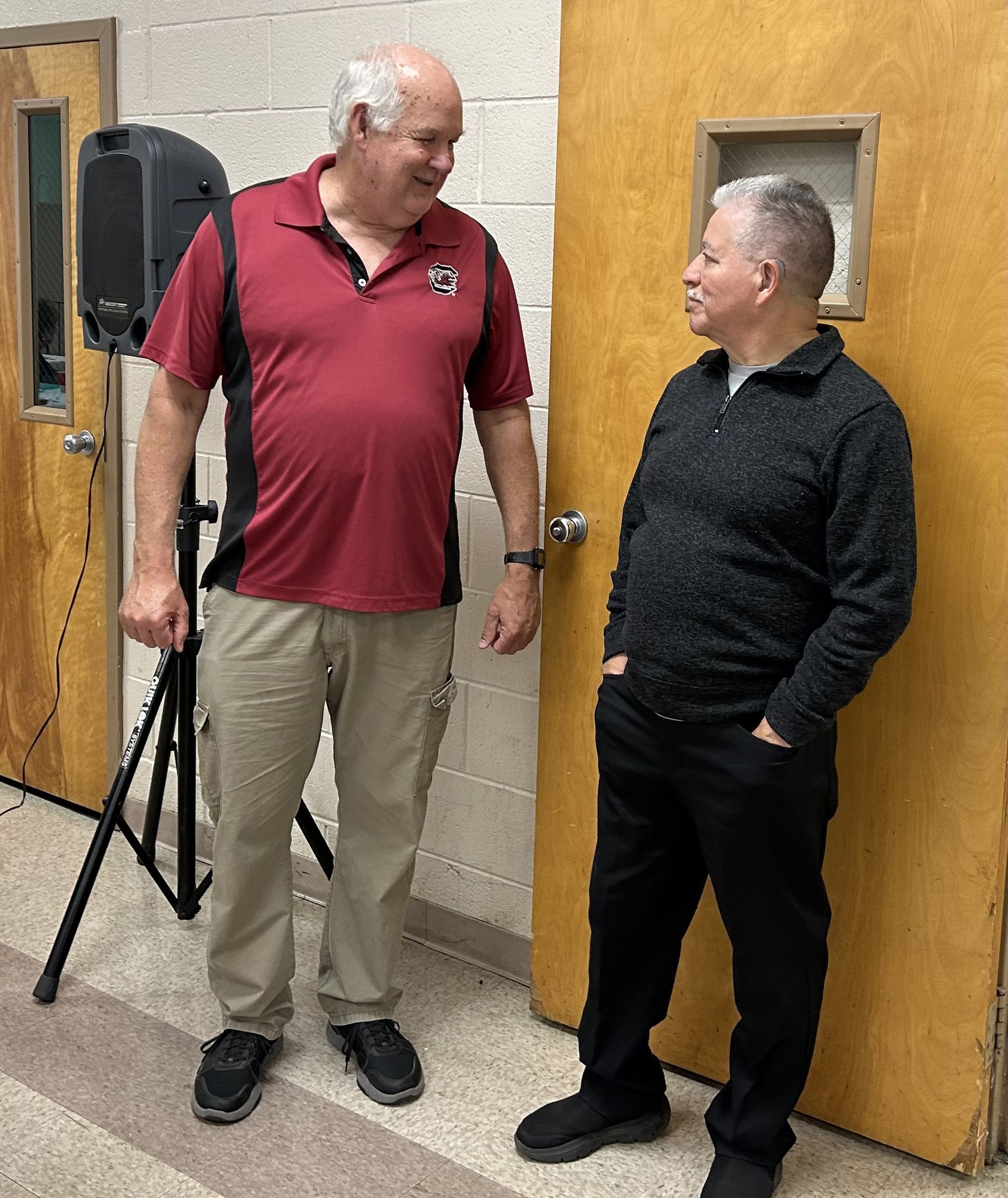 A group of people sitting in a row with Bibles on their lap