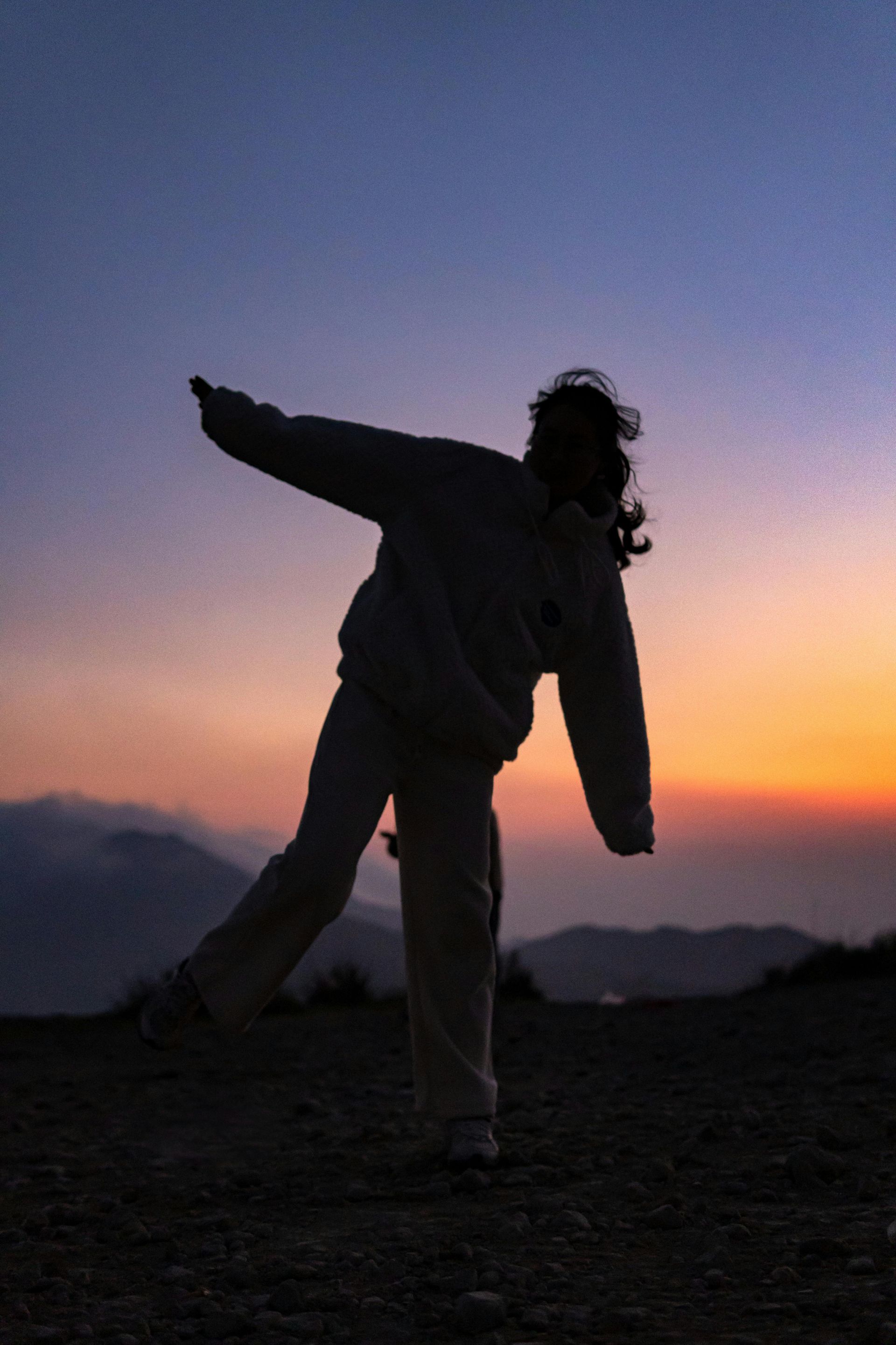 A man and a woman are holding hands with a string of lights.