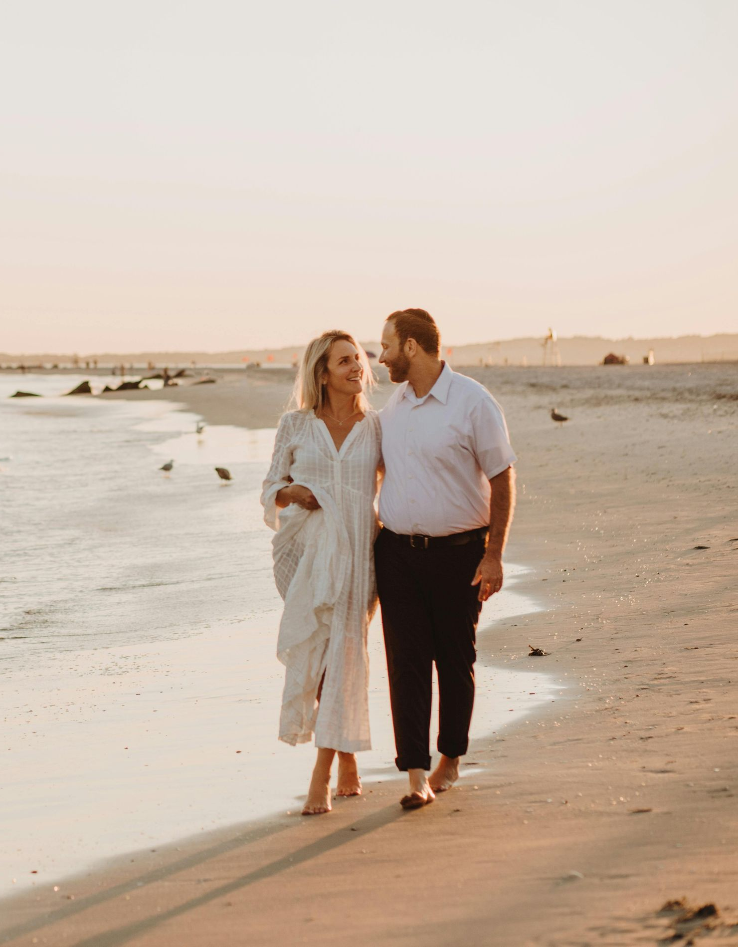 A black and white photo of a crowd of people raising their hands in the air.