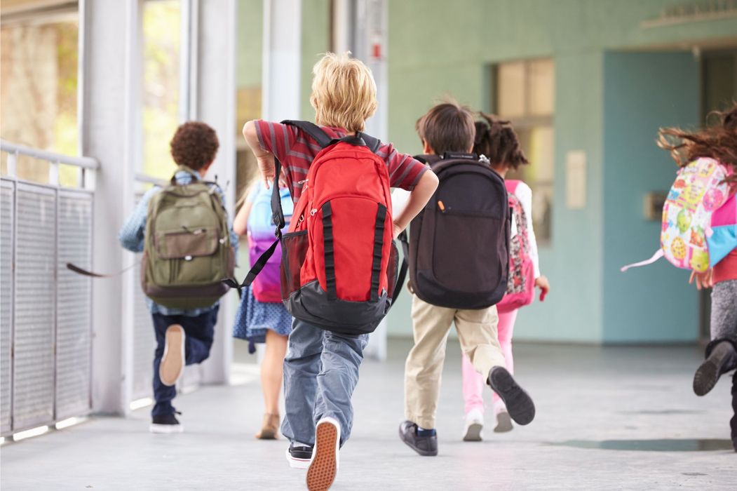 children with backpacks as they enter school