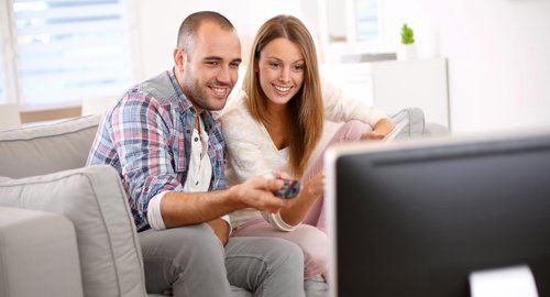 Couple watching TV in Nelson