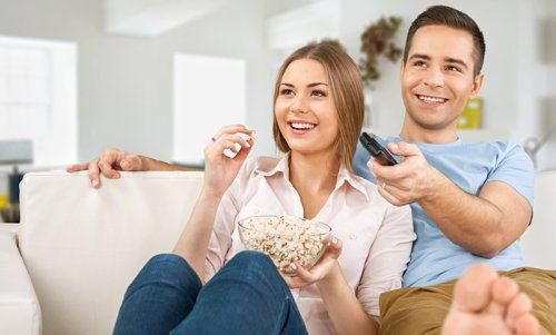 Couple having fun watching TV