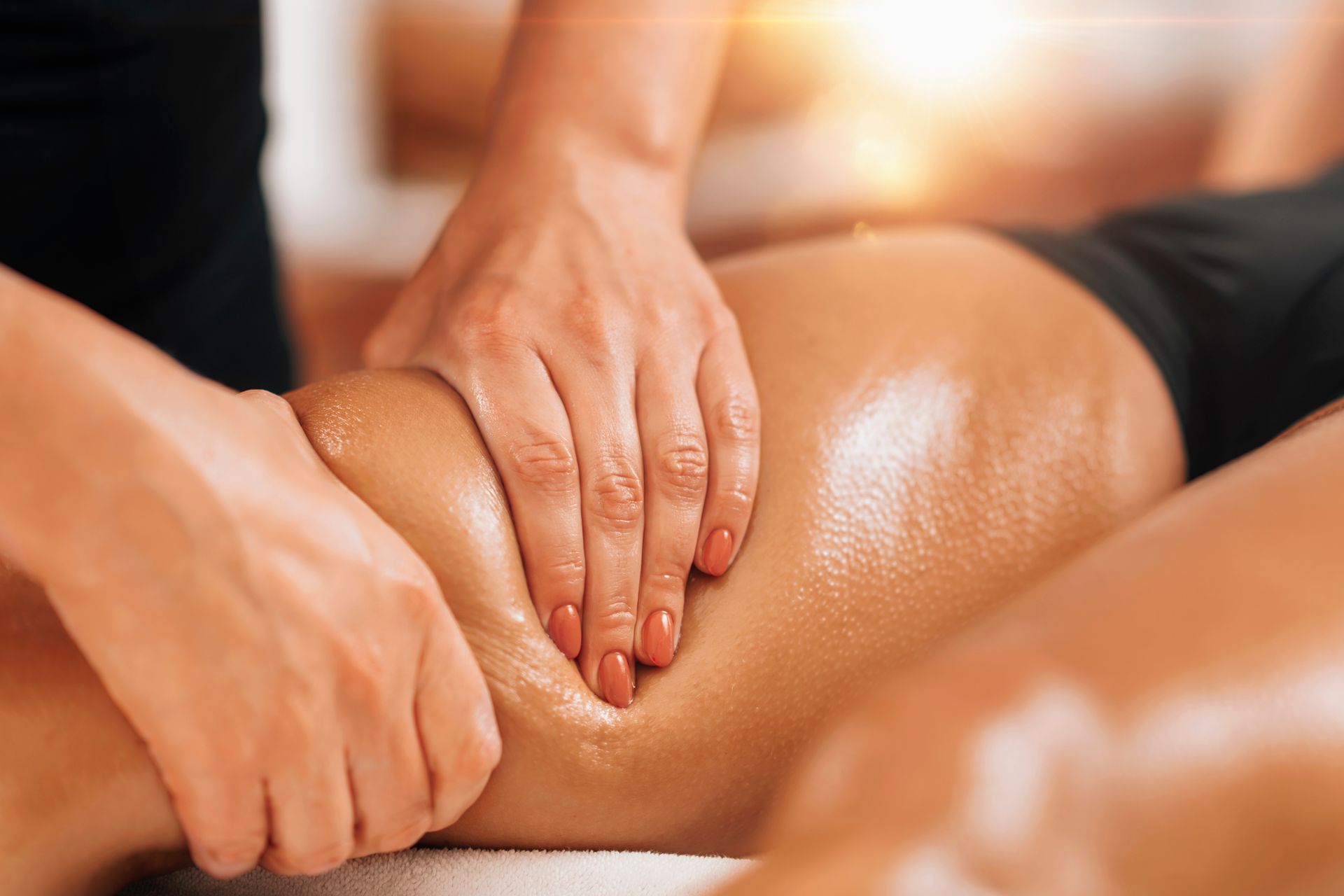 A woman is getting a massage on her leg in a spa.