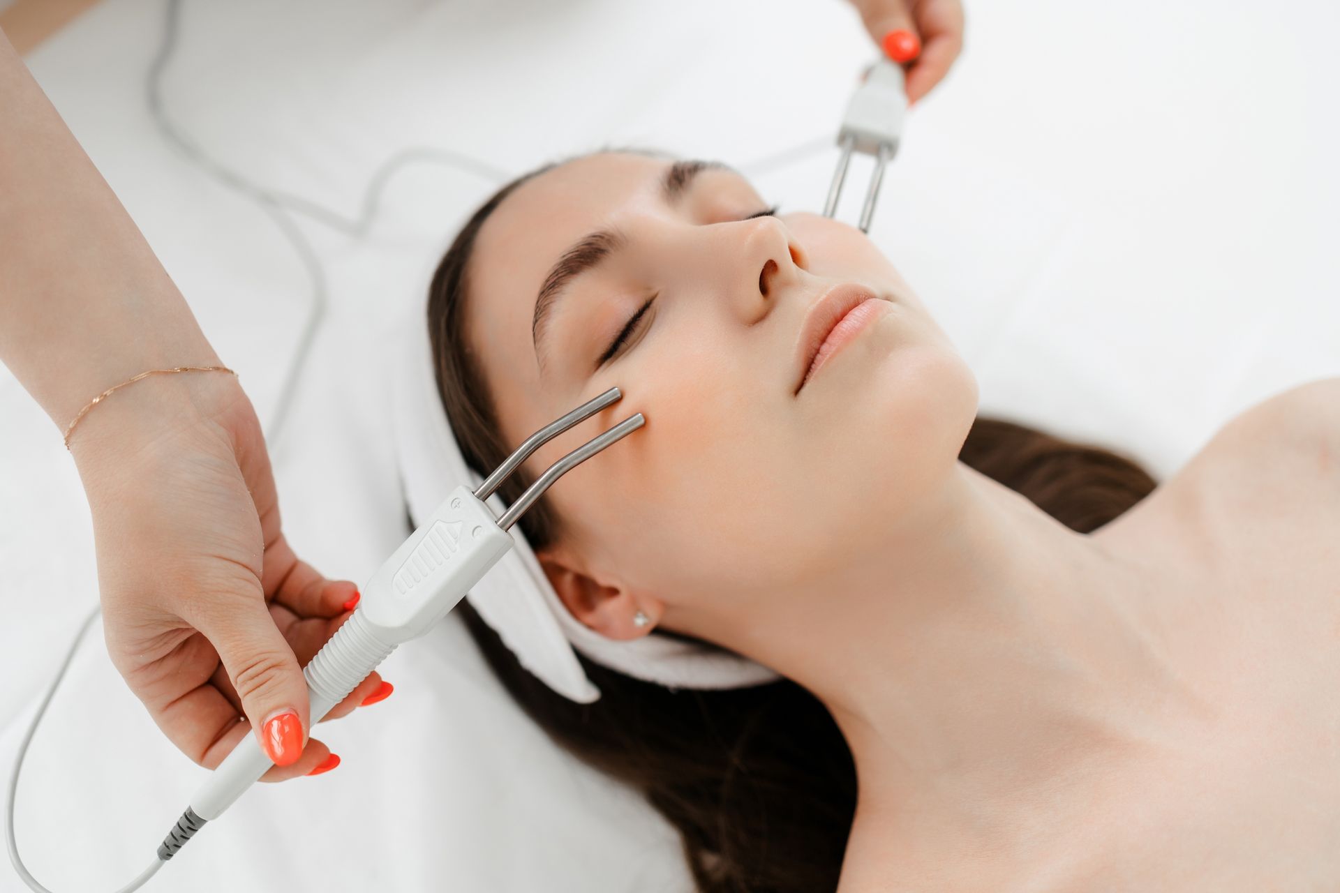 A woman is getting a facial treatment at a beauty salon.