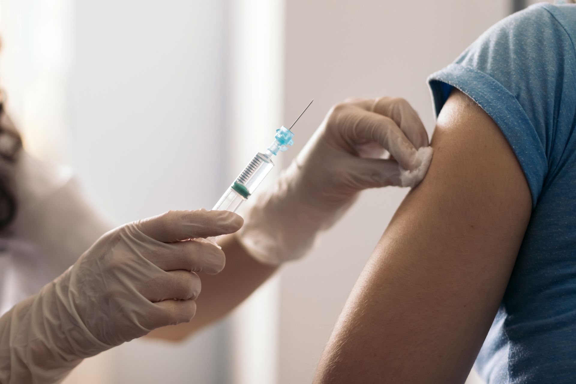 A woman is getting an injection in her arm.