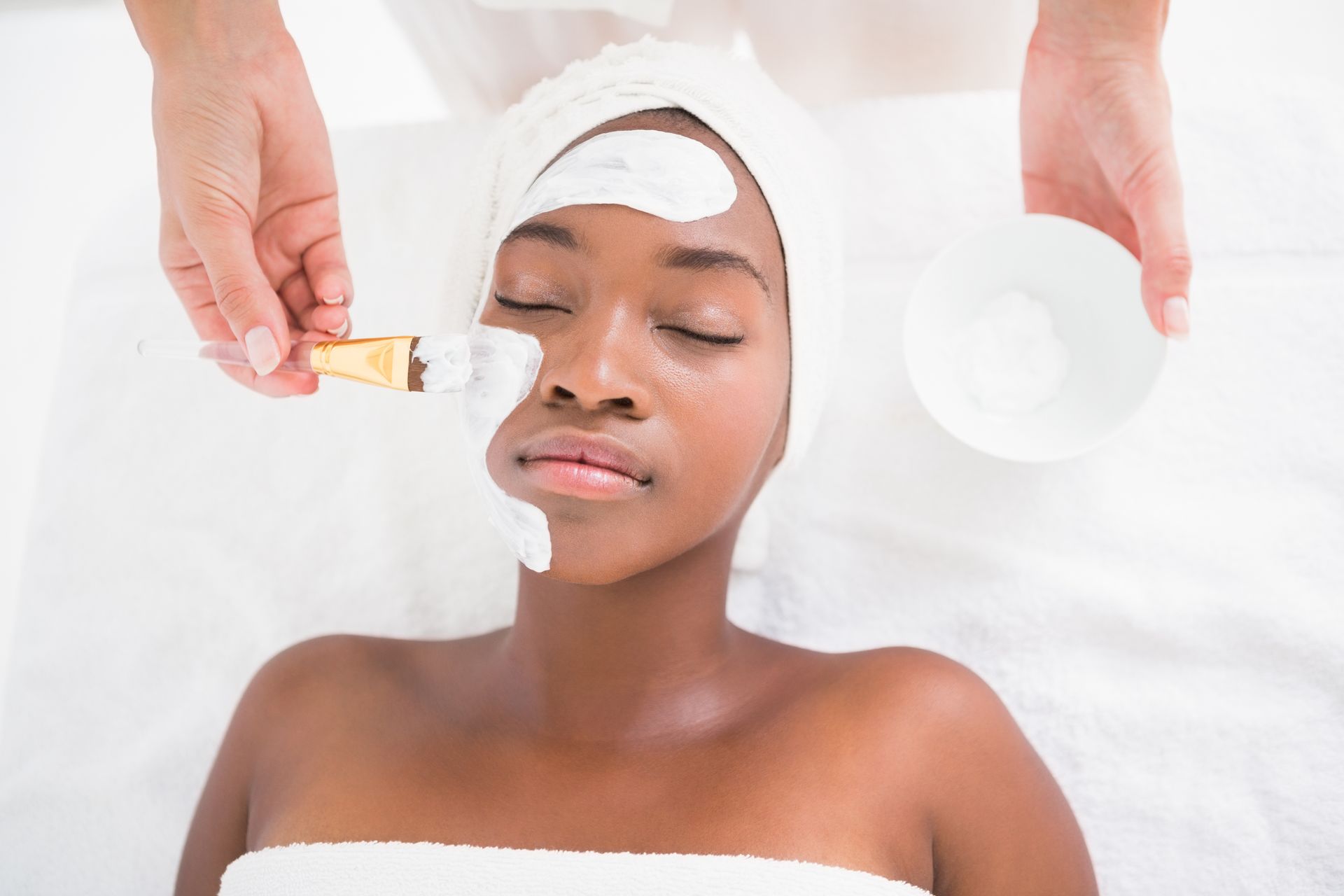 A woman is getting a facial treatment at a spa.