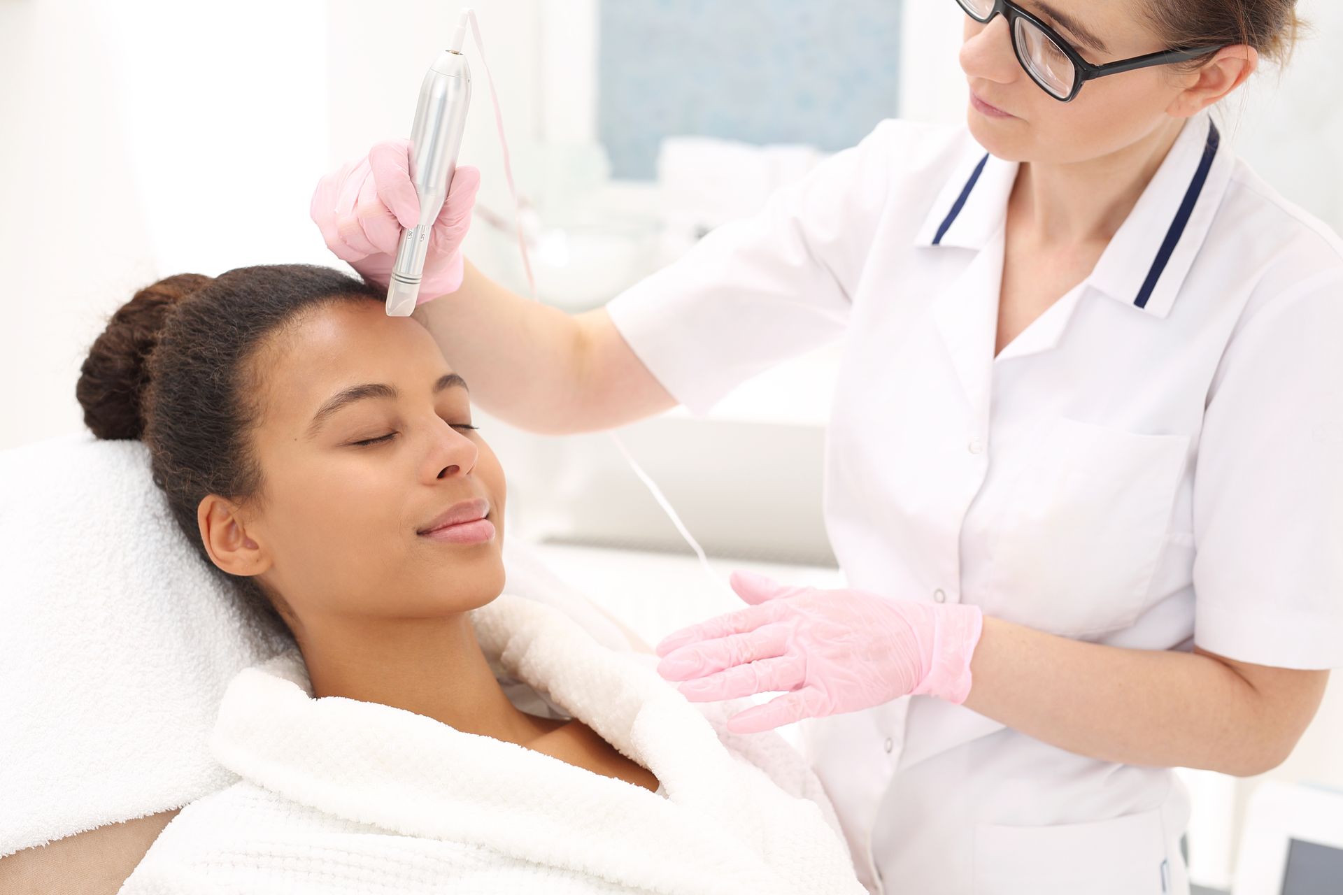 A woman is getting a facial treatment at a beauty salon.