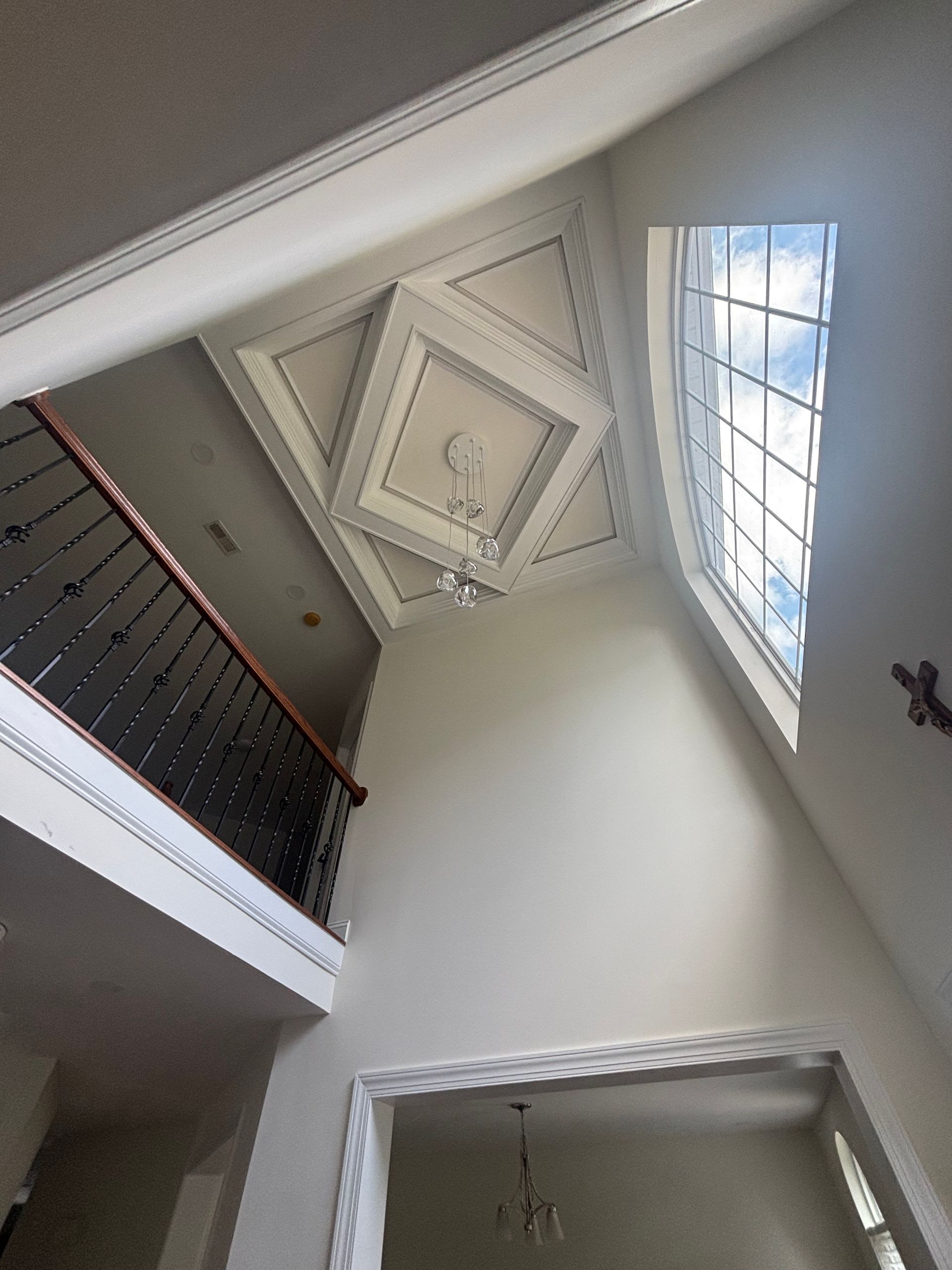 Electrician working on an electrical panel, wearing gloves and using a multimeter.