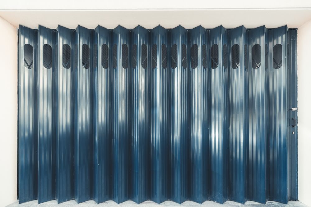 A close up of a blue folding door in a room.