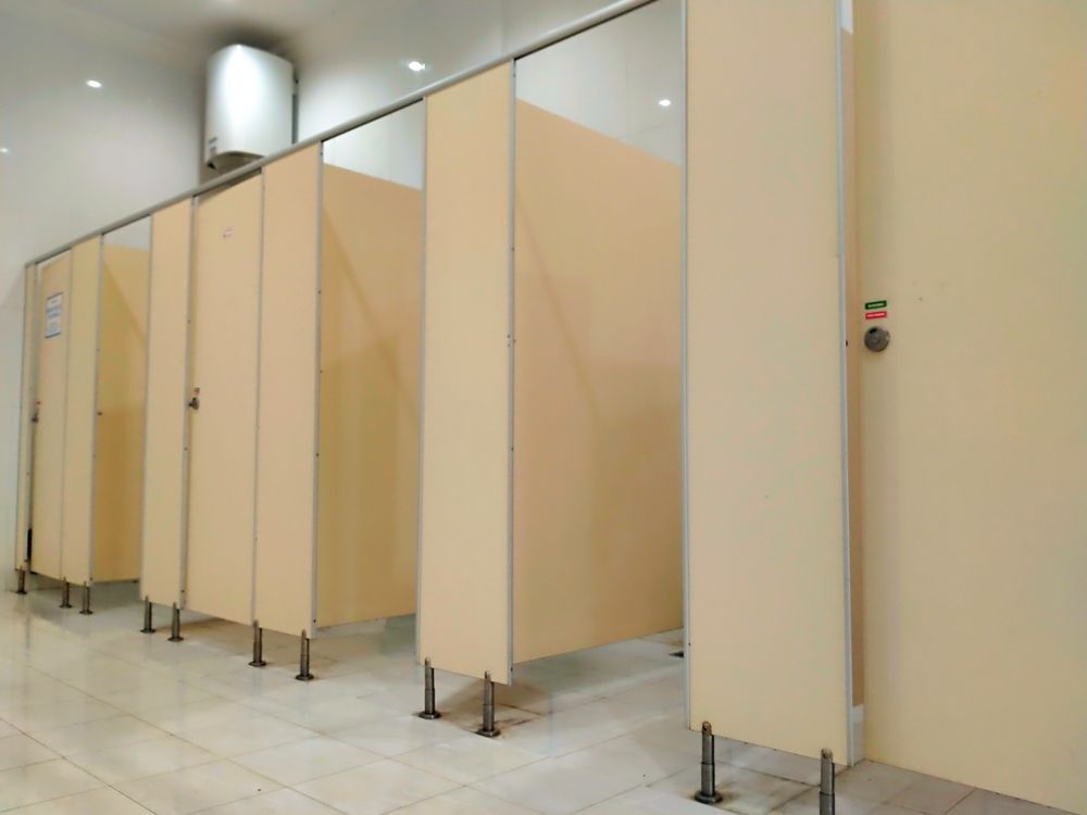 A row of toilet cubicles in a public restroom.