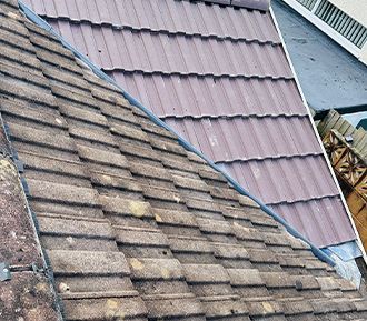 A close up of a roof with a lot of tiles on it.