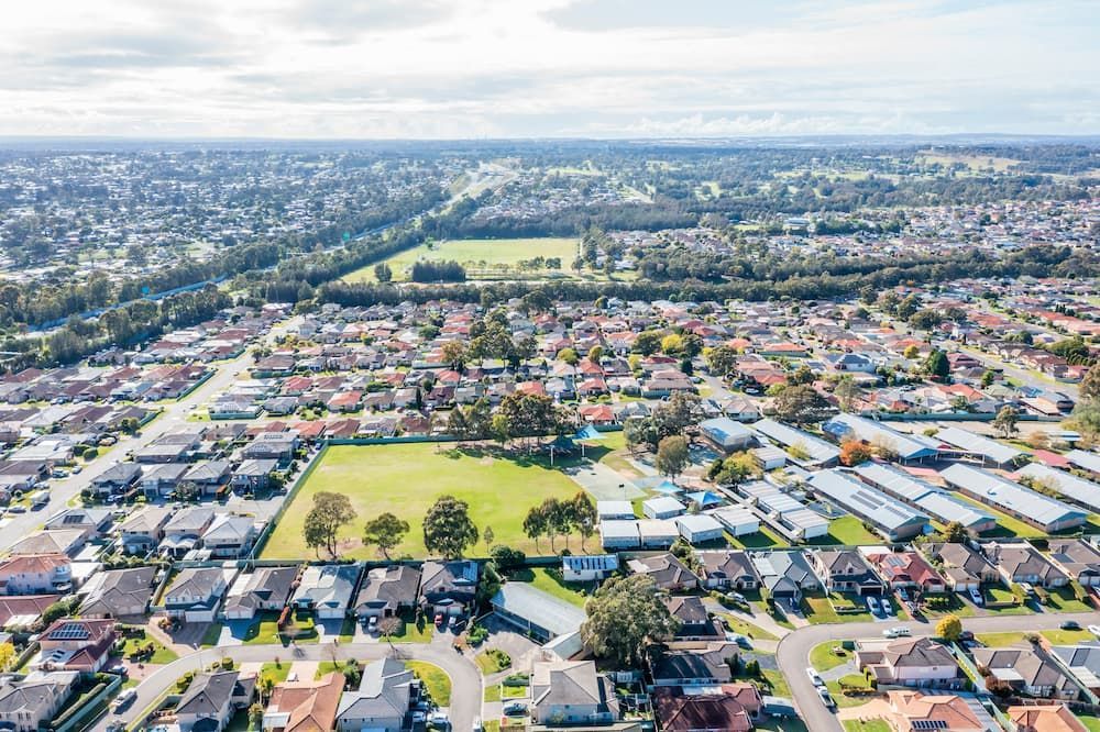 An Aerial View Of A Residential Area With Lots Of Houses And Trees — KeyBay in The Oaks, NSW