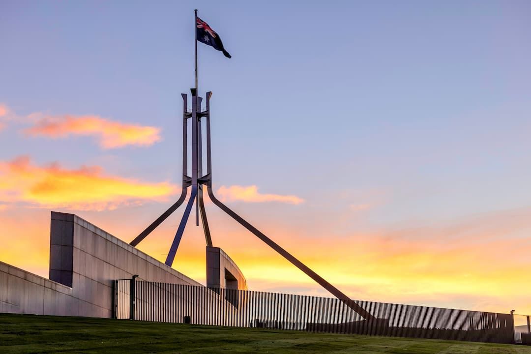 Large Building With a Flag on Top of It at Sunset — KeyBay in Southern Highlands, NSW