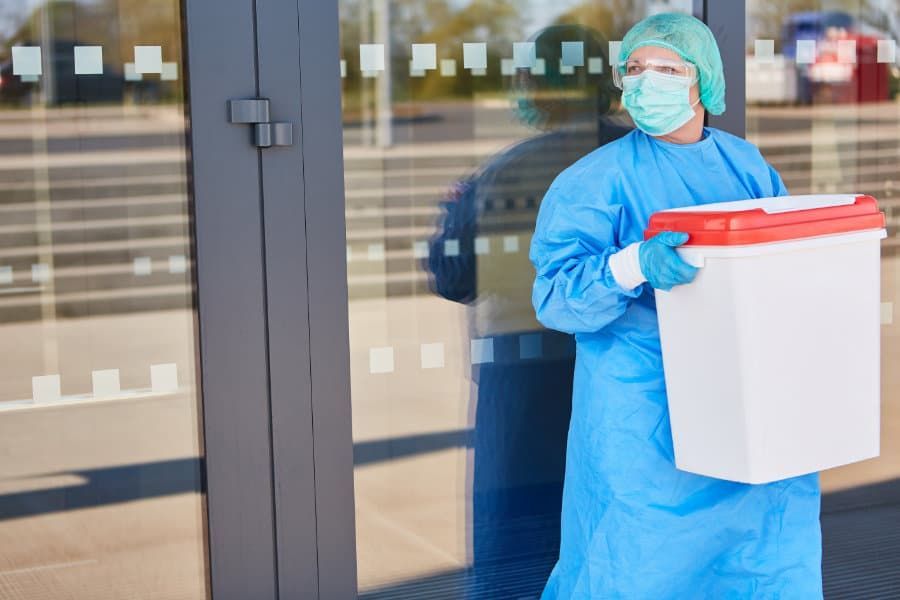 Surgeon Wearing a Mask and Gown is Carrying a Large Container — KeyBay in Marulan, NSW