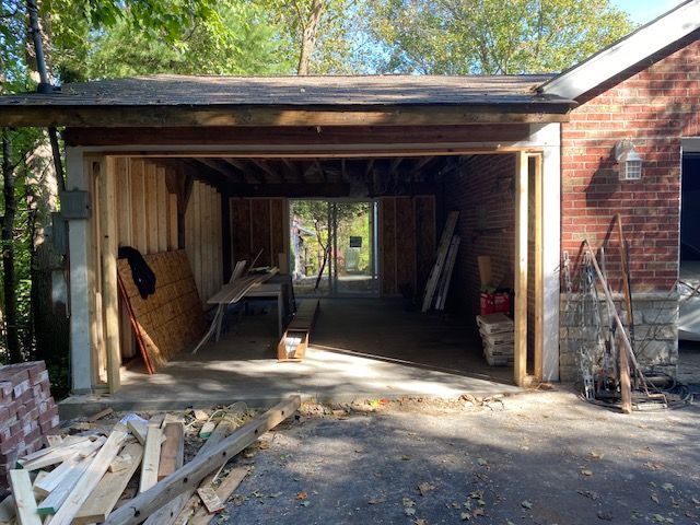 A garage is being remodeled in a brick house.