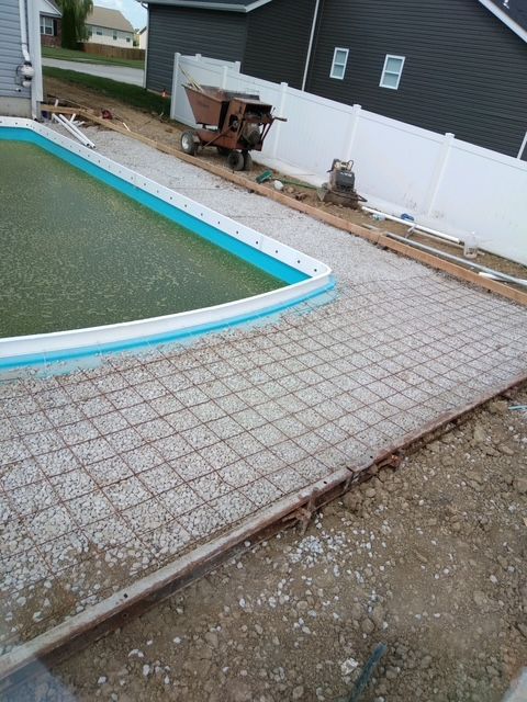 A swimming pool is being built in the backyard of a house