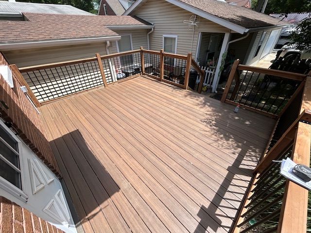 An aerial view of a wooden deck in front of a house.