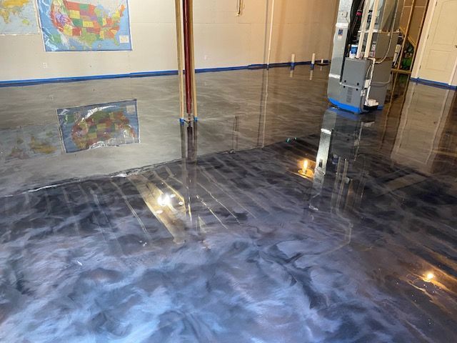 A room with a shiny metallic floor and a map of the united states on the wall.