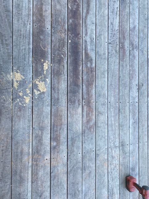 A pair of dumbbells are sitting on a wooden floor.
