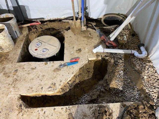 A manhole cover is being installed in a hole in the ground.