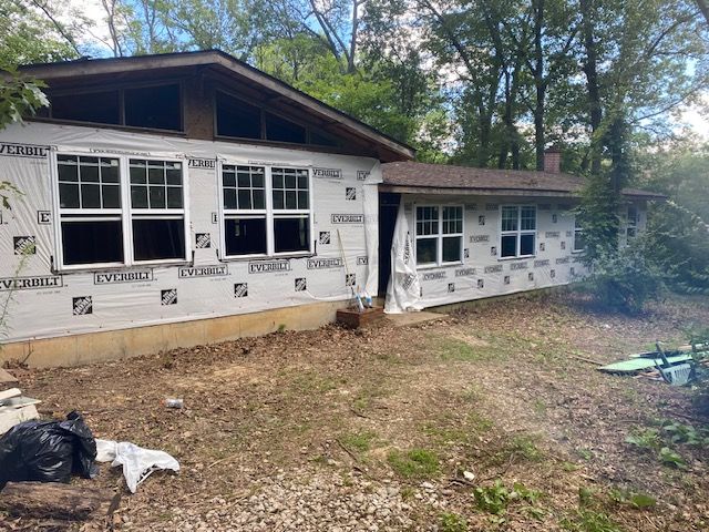 A house with a lot of windows is being remodeled.