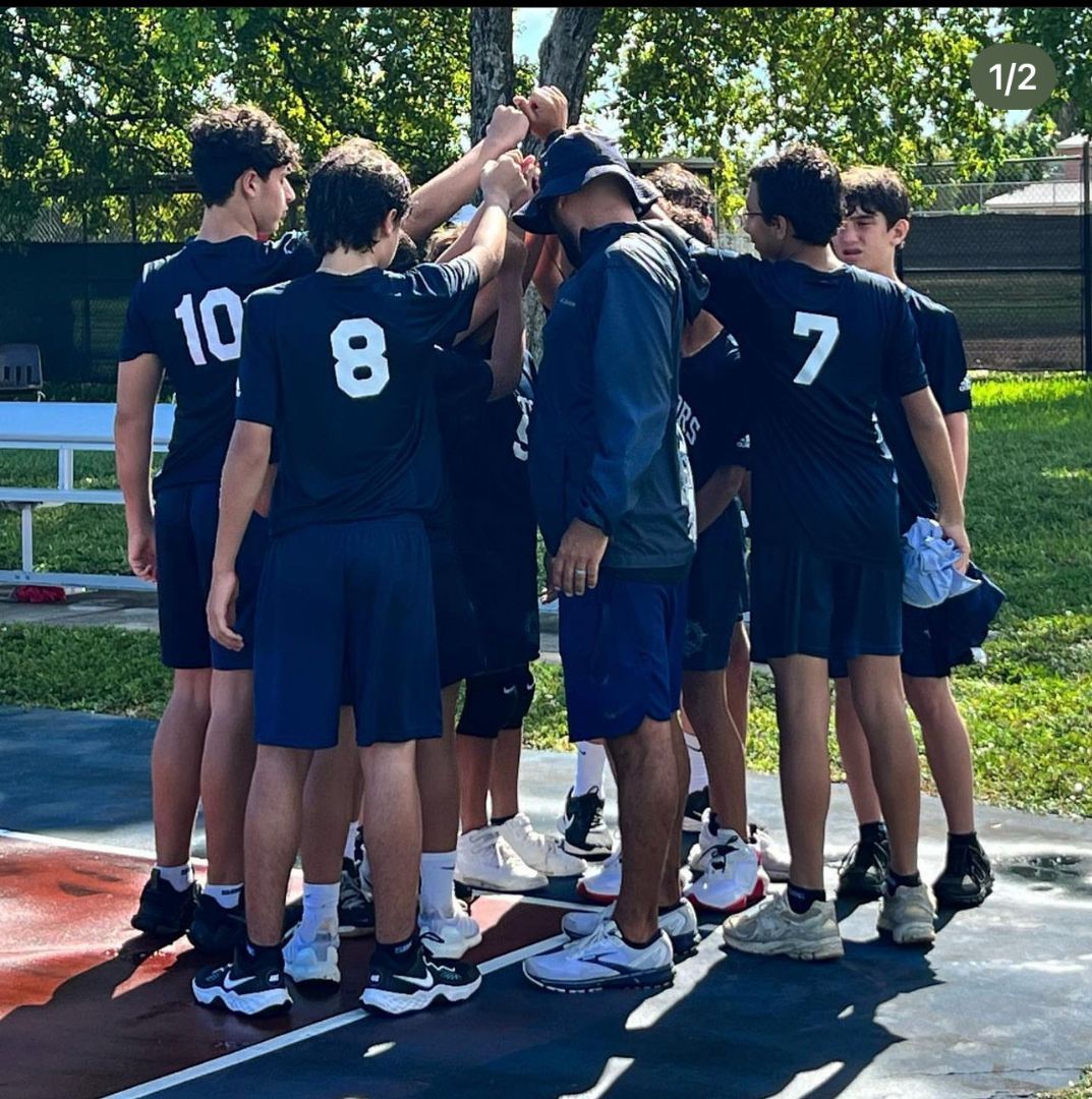 A group of boys wearing jerseys with the numbers 10 8 and 7 huddle together