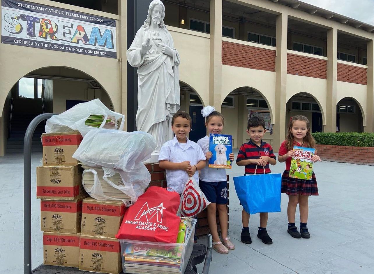A group of children standing in front of a stream sign