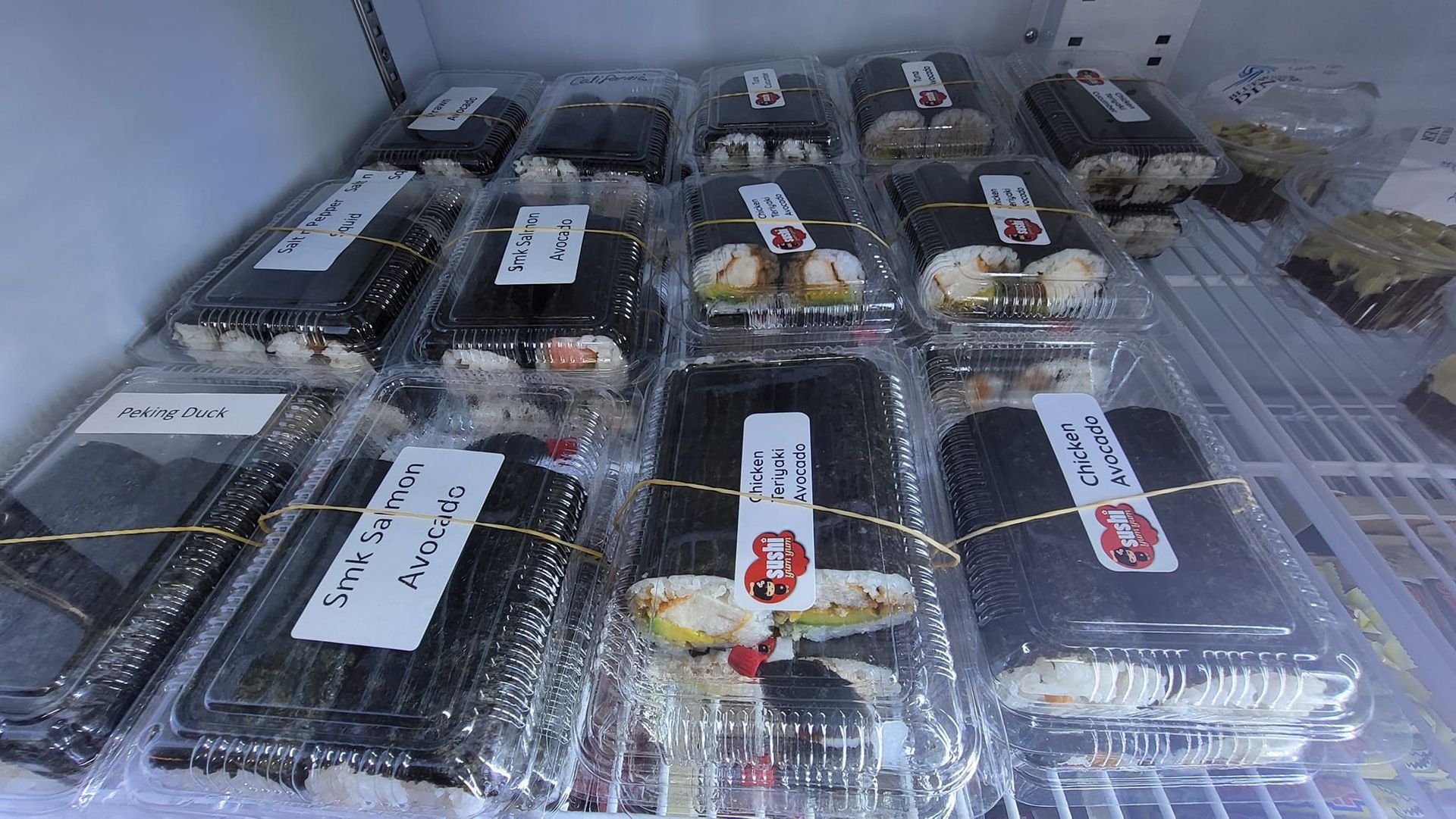 Sushi Rolls in Clear Plastic Containers on a Shelf in a Refrigerator — Bluewater Diner in Bluewater, QLD