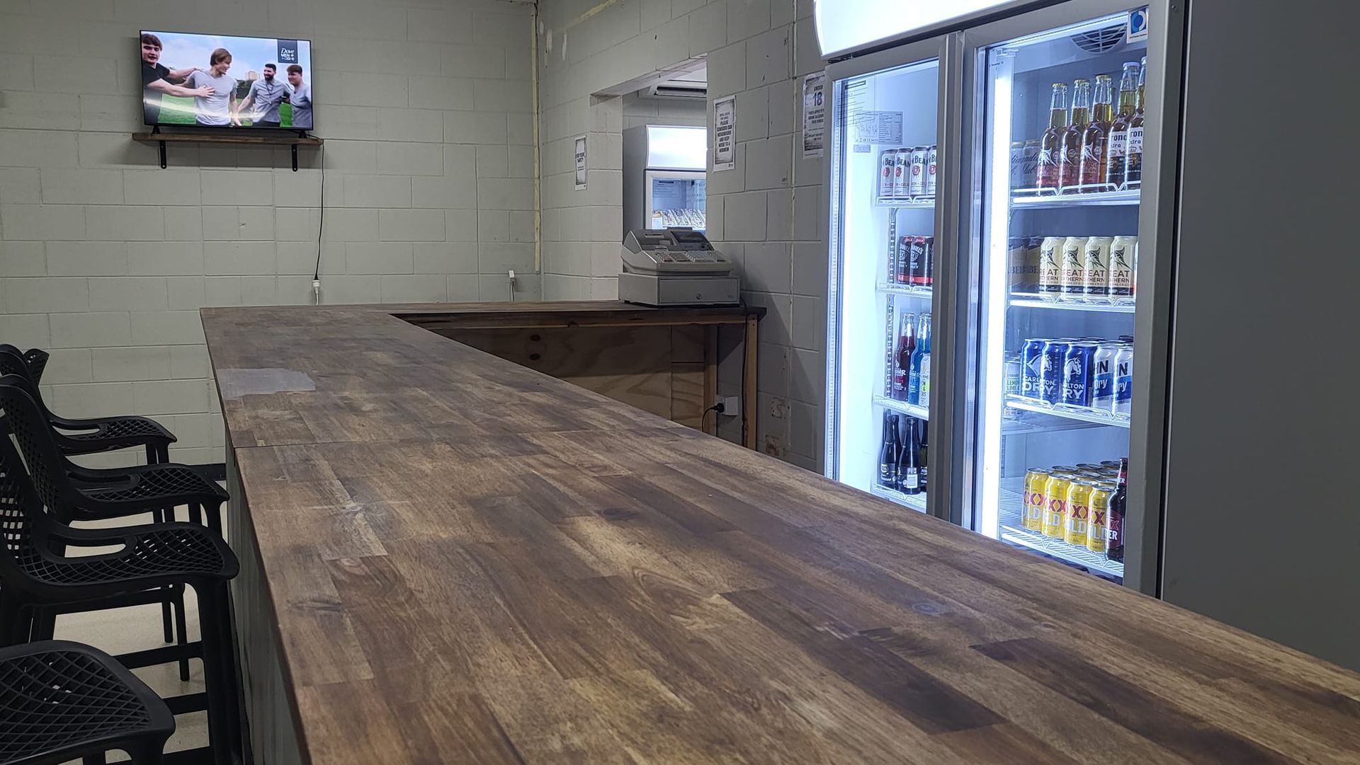 Bar With Wooden Counter, Stools, and Refrigerated Drinks — Bluewater Diner in Bluewater, QLD