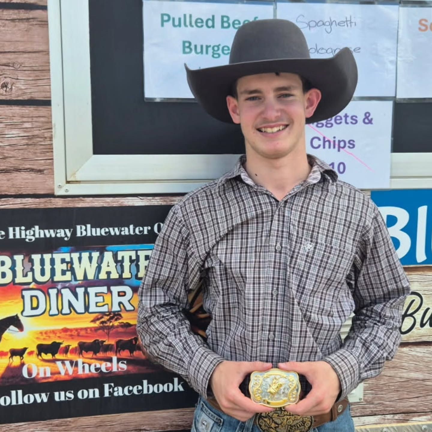 People Seated at a Long Table, Some Wearing Hats, With a Child Smiling in the Foreground — Bluewater Diner in Bluewater, QLD