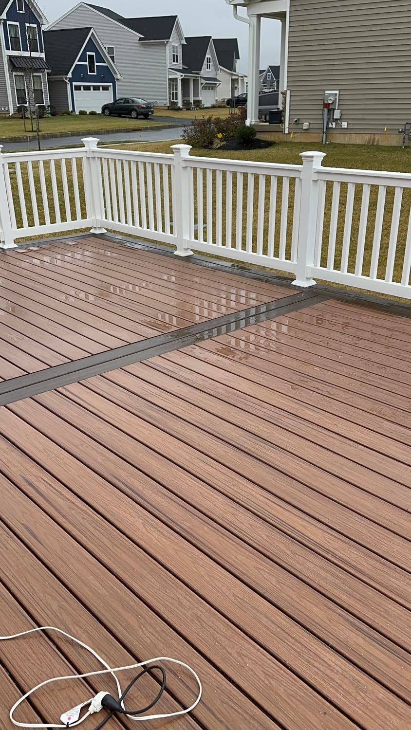 A wooden deck with a white fence and a light on it.