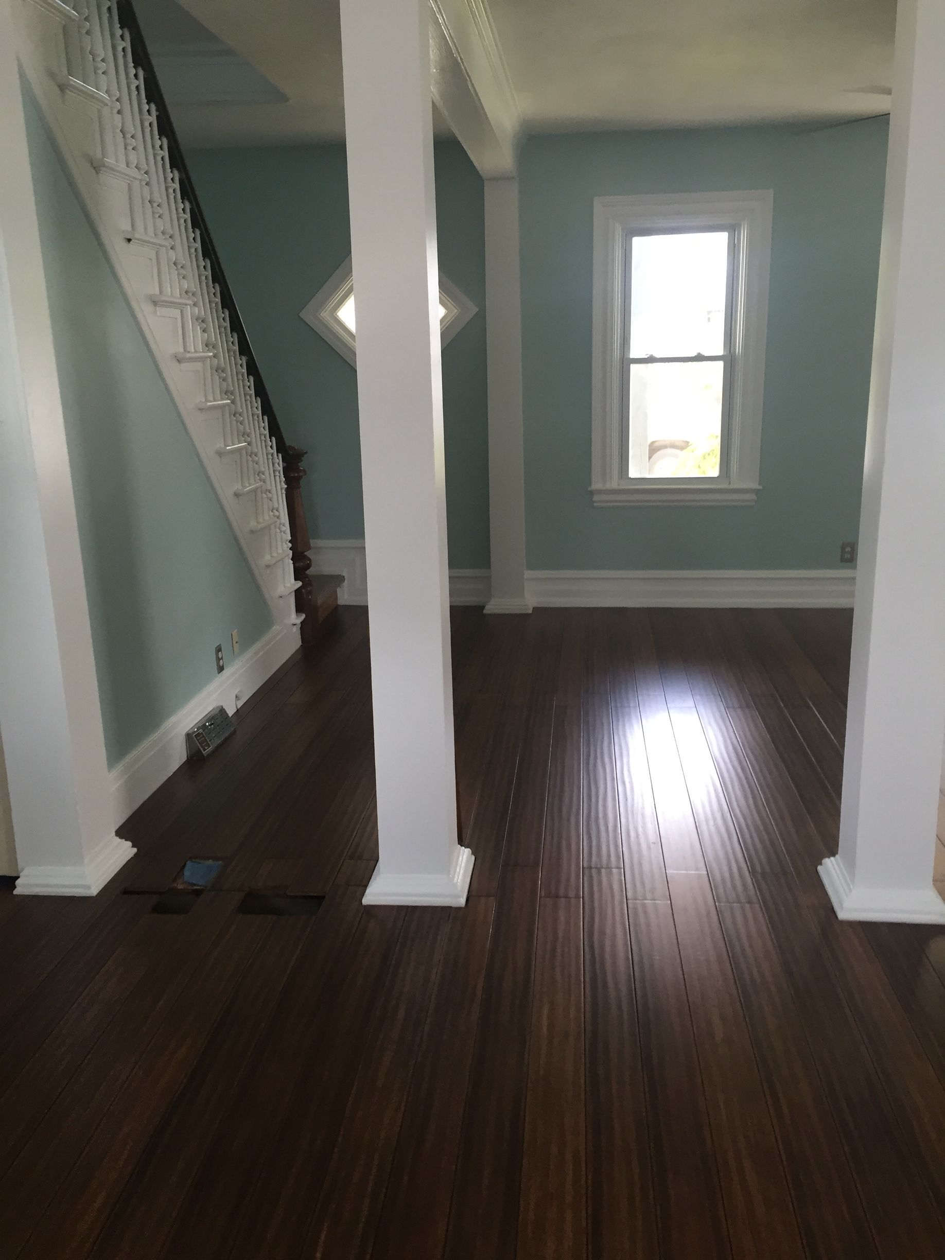 An empty room with a staircase and a window