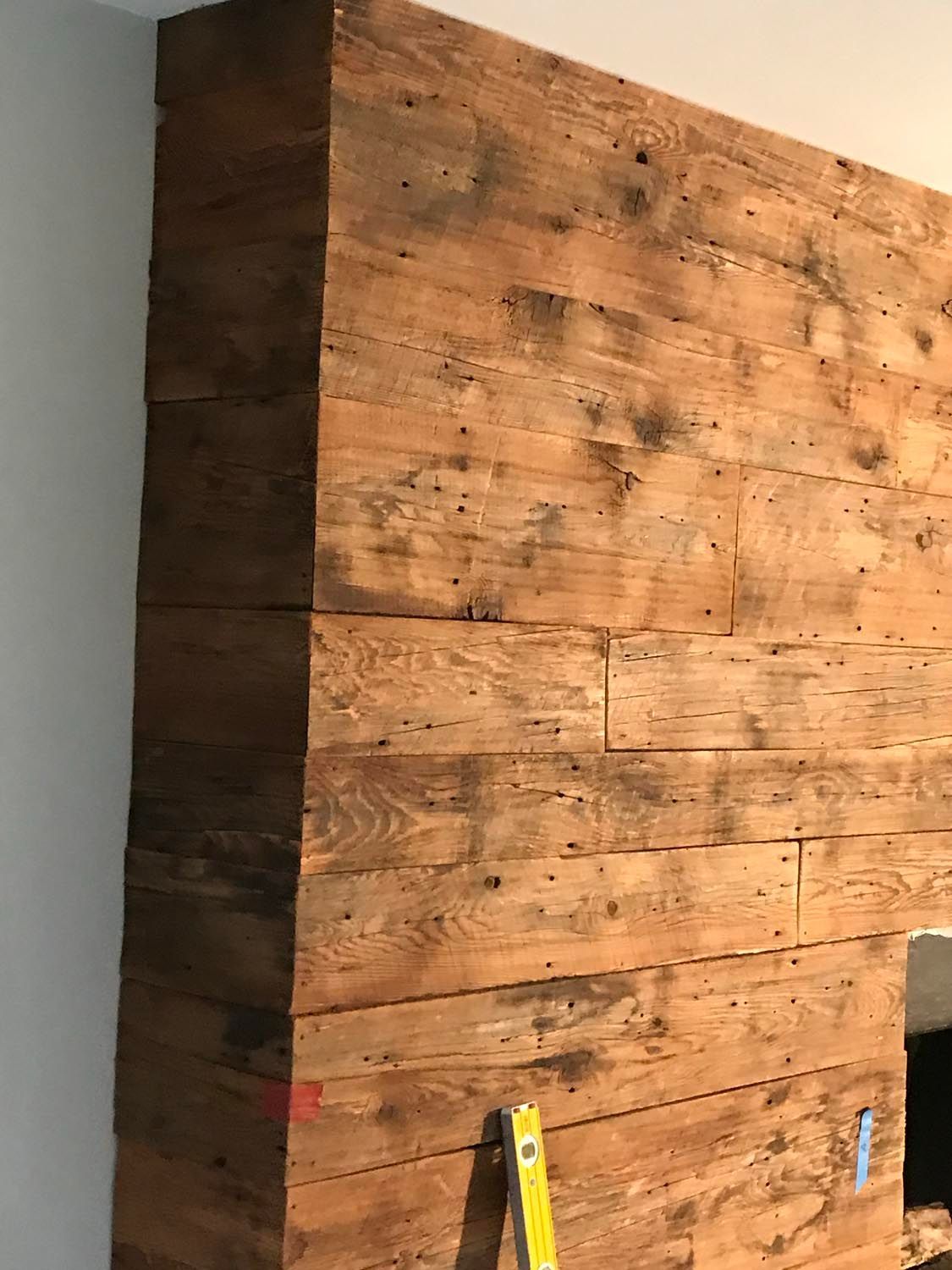 A wooden wall with a ladder leaning against it.