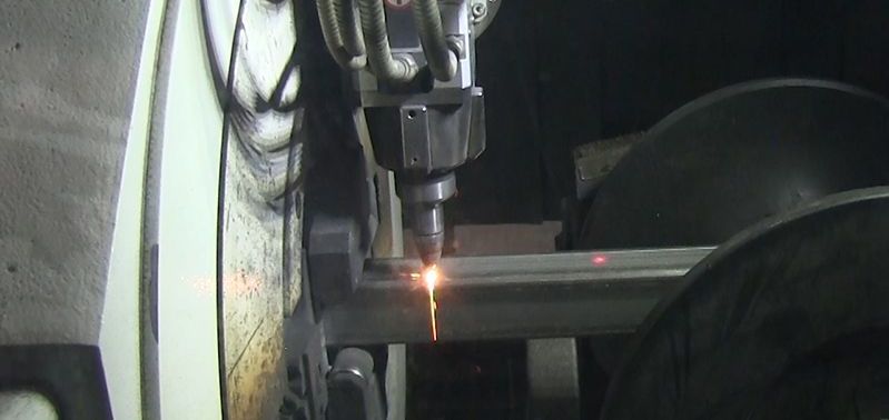 A machine is cutting a piece of metal with a laser.