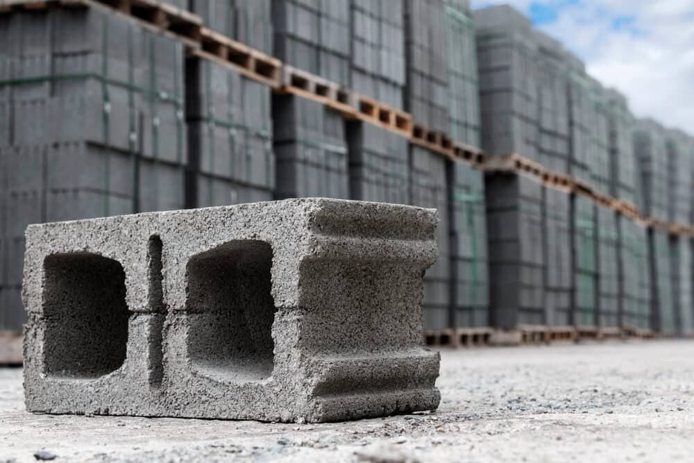 A Concrete Block Is Sitting On The Ground In Front Of A Row Of Concrete Blocks — Mascrete Pty Ltd In Hermit Park, QLD